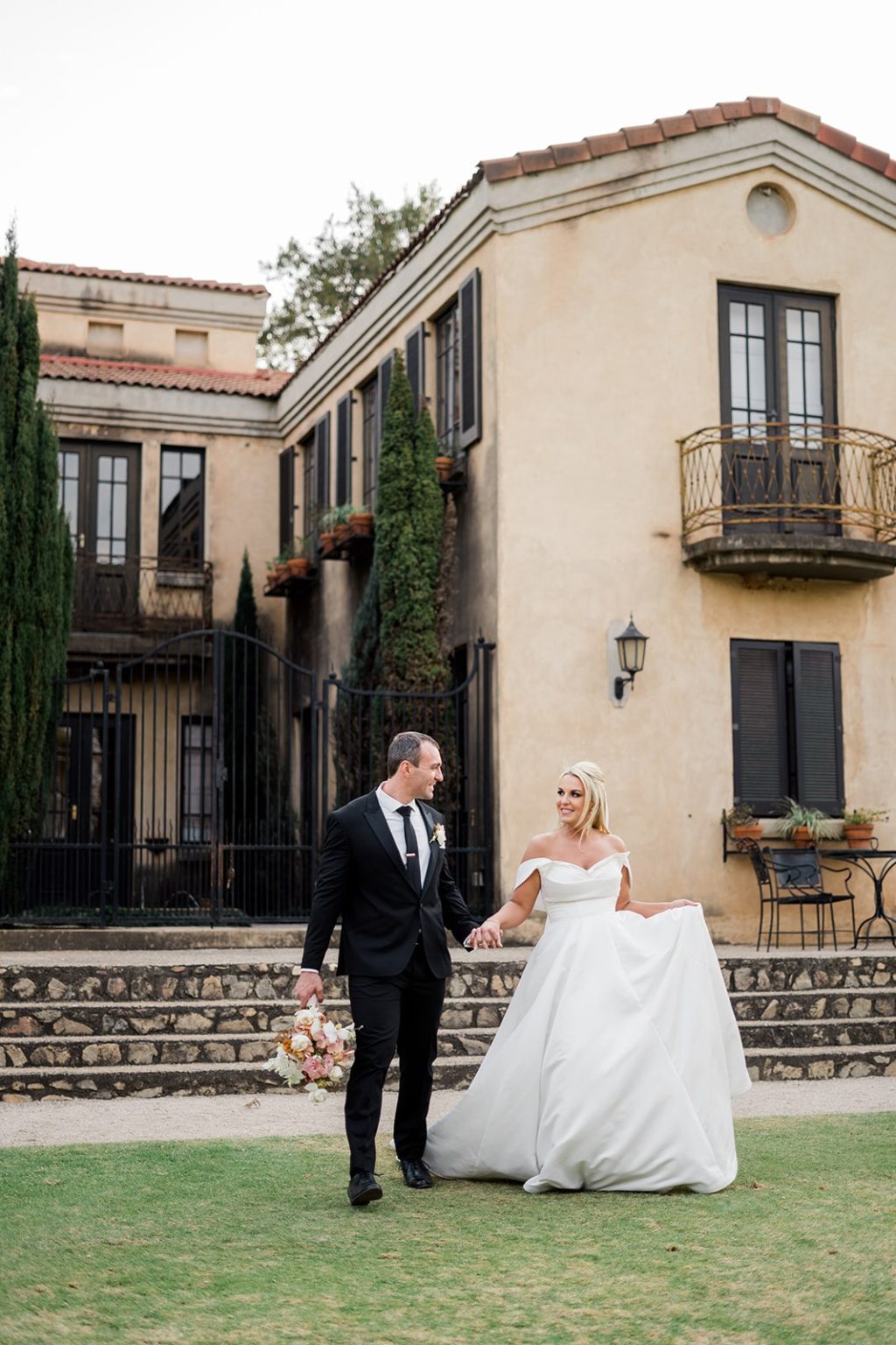 bride and groom holding hands walking in picturesque garden in johannesburg